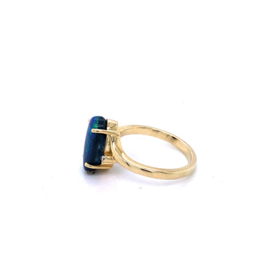 9Ct Yellow Gold Oval Blue/Green 12Mm X 8Mm Solid Lightening Ridge Black Opal Claw Set And Diamond Crossover Style Ring. Size P